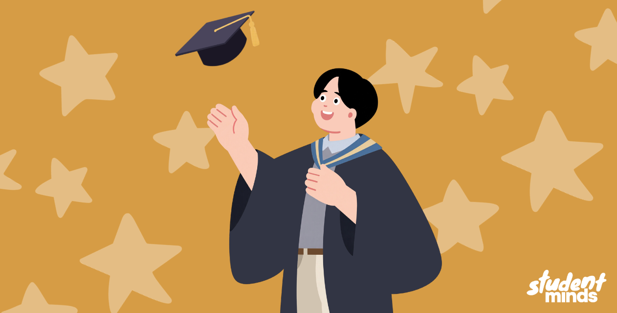male in graduation gown throwing his hat