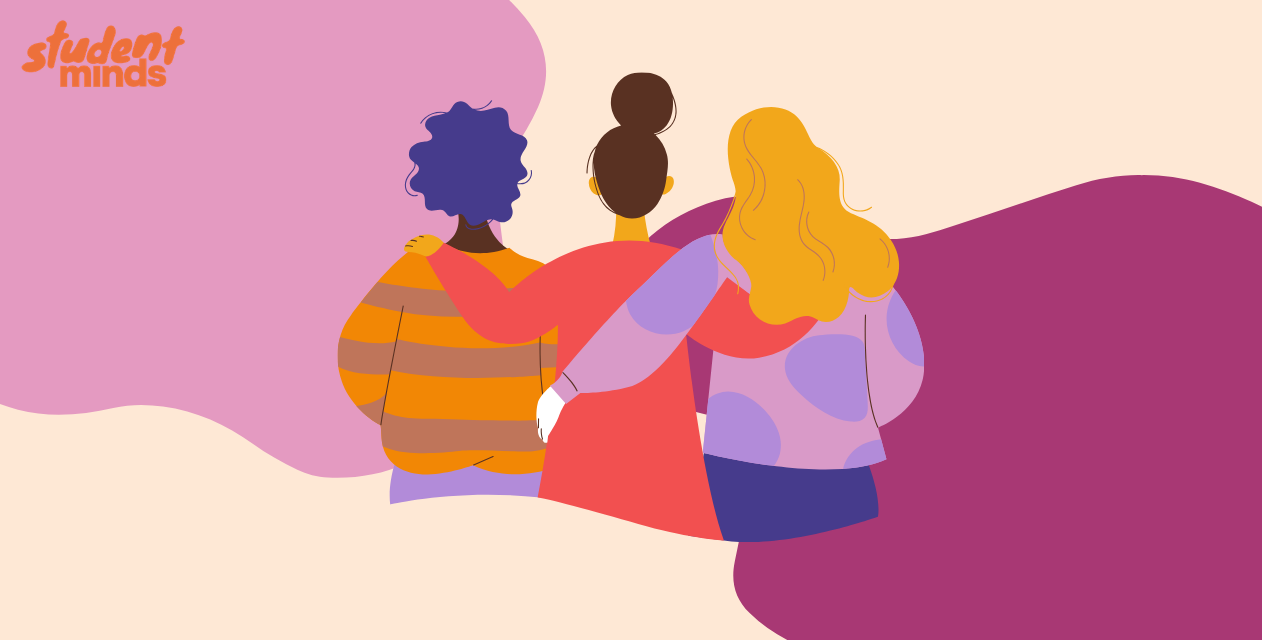 Three people sat with arms around each other